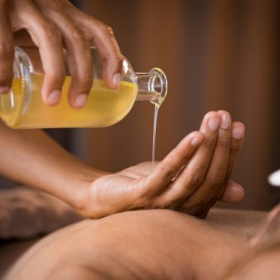 therapist-pouring-massage-oil-spa_256588-741